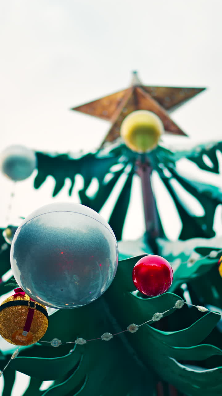 Close up of decorations on a metal rotating Christmas tree. Vertical