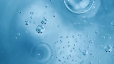 Oxygen-bubbles-in-water-on-a-blue-abstract-background-on-super-slow-motion.