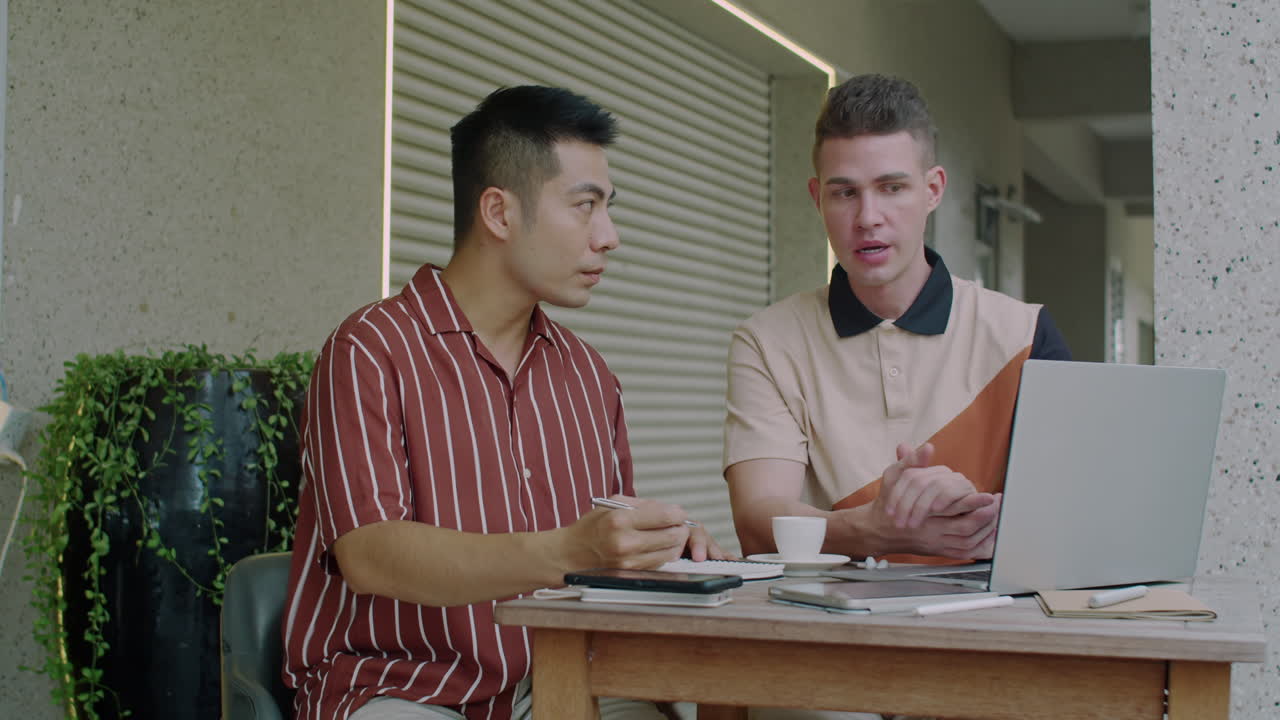 Businessmen Meeting Outdoors to Discuss Financial Report