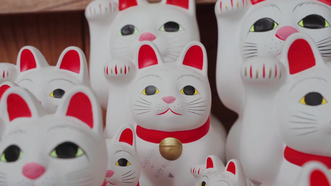 Lähikuva-video sadoista ikonisista Maneki Neko -onnenkissapatsaista Gotokuji-temppelissä Tokiossa, esitellen maan kuuluisimpia onnen, vaurauden ja perinteisen japanilaisen kulttuurin symboleja
