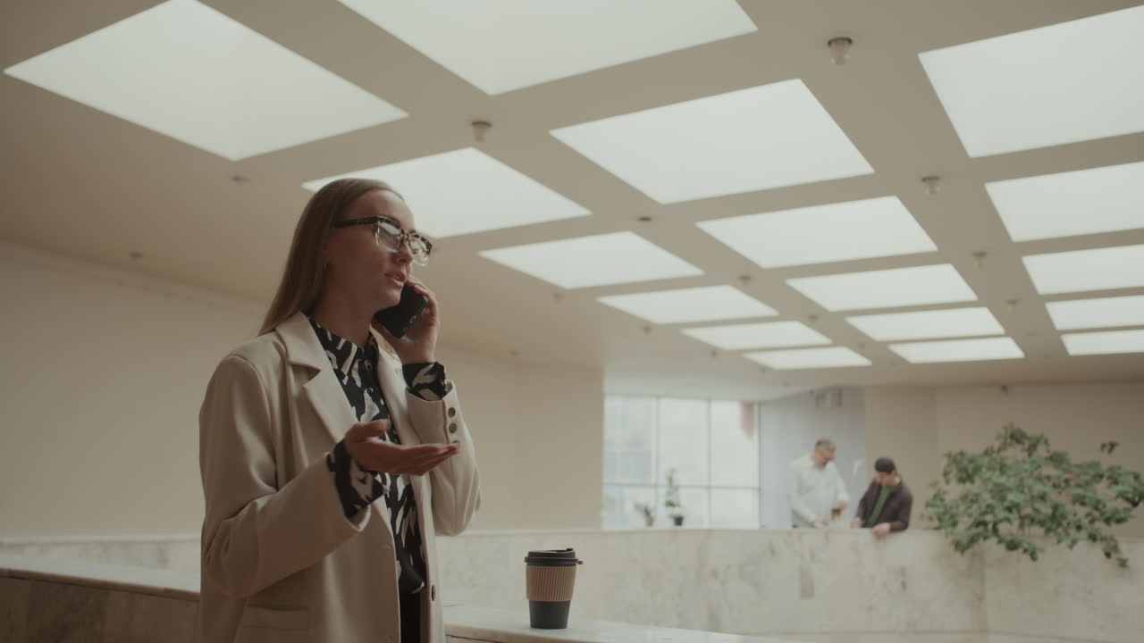 Professional Businesswoman Talking on Mobile Phone in Modern Office