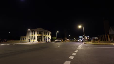 coches que pasan por una encrucijada iluminada por la noche