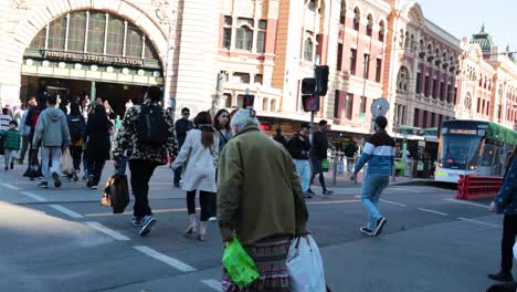 crowds crossing street near historic train station