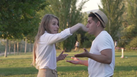 young couple arguing in the park