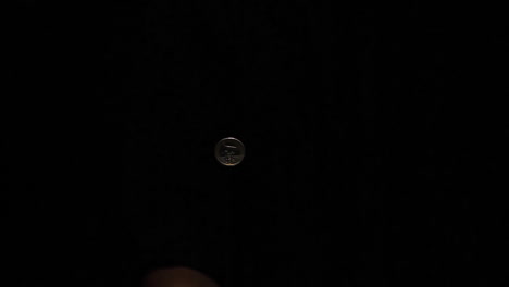 hand flipping a coin