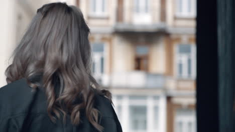 blonde girl walking urban city landscape at daytime near modern architecture.