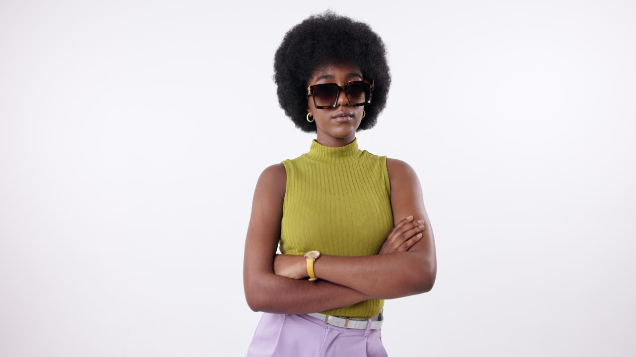 A woman with an afro wearing sunglasses