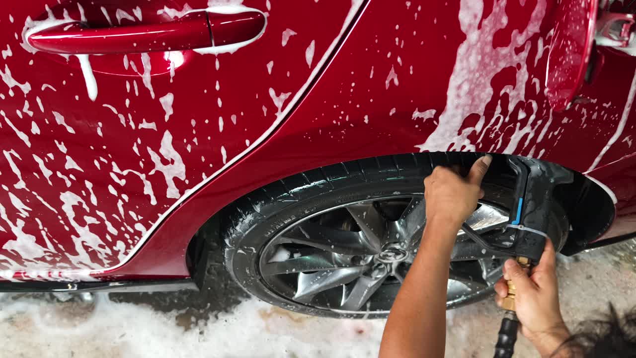 Red Car Being Washed with Soap and Foam