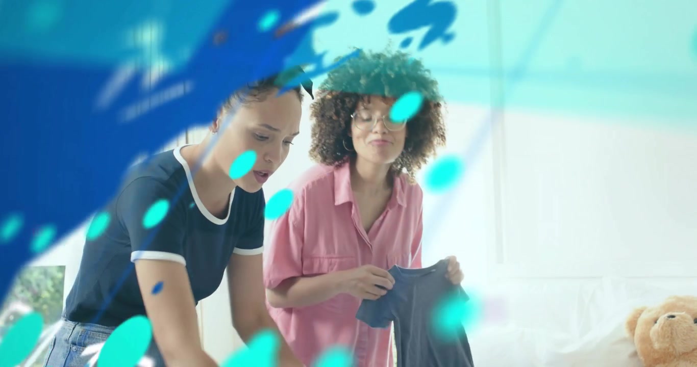 Two women approaching bed sorting laundry and making bed for neat room under technology overlay