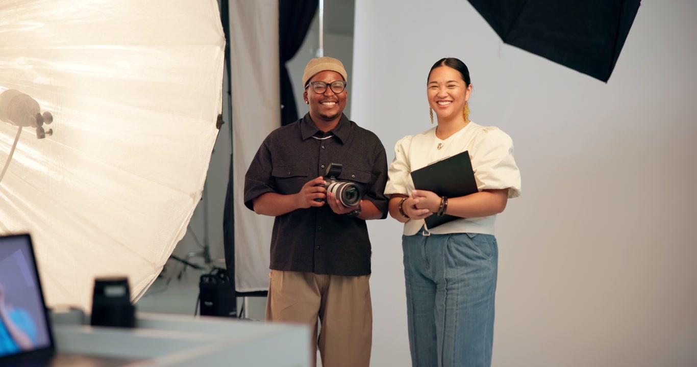 Professional Photographer and Assistant Smiling in a Photo Studio