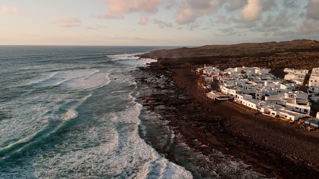 Stunning aerial drone footage of El Golfo, located within Timanfaya National Park in Lanzarote, Canary Islands, captured at sunset.