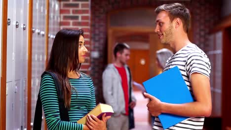 Two-students-laughing-and-talking-in-the-hallway