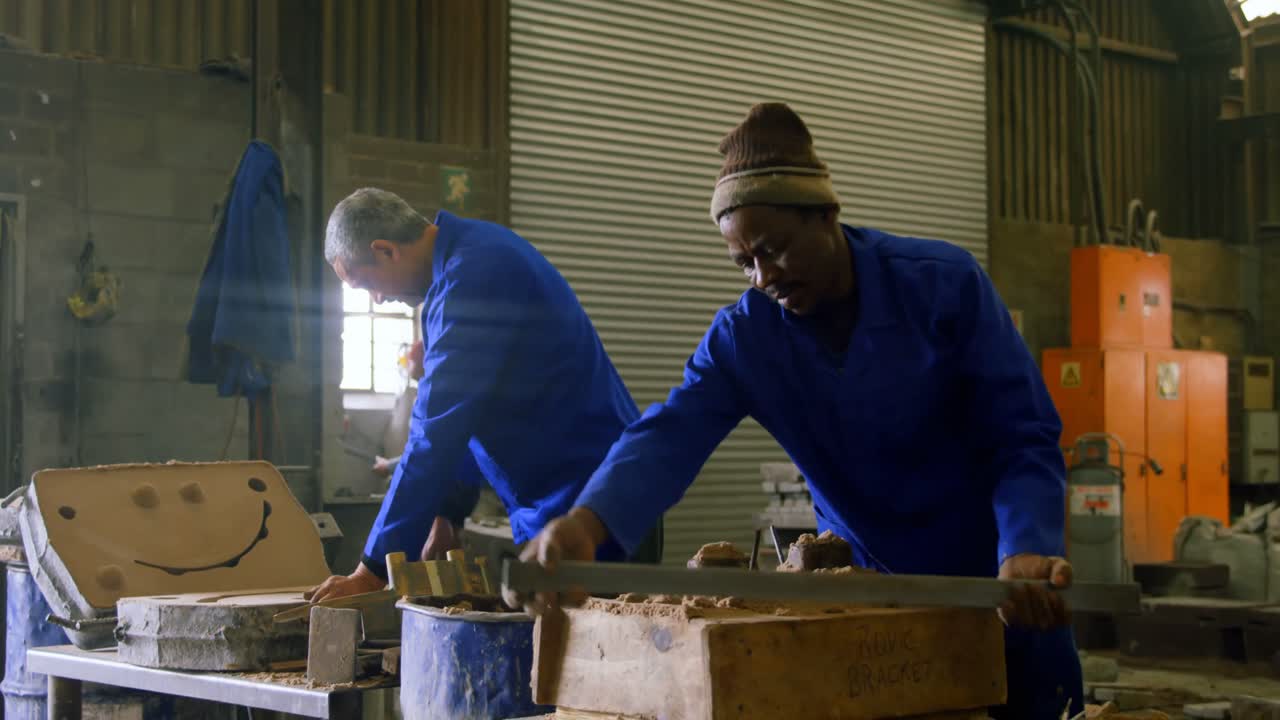 Workers putting soil in wooden molds in workshop 4k