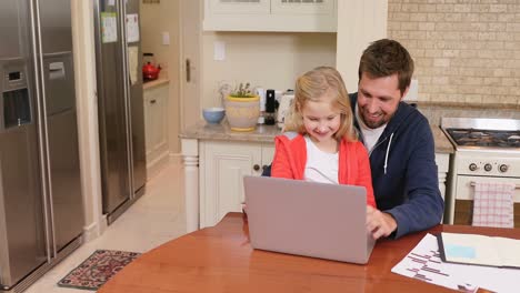 smiling father and daughter sitting on chair using laptop 4k 4k