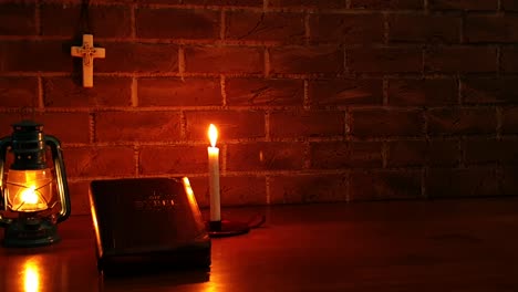 Closed-Bible-on-table-with-candle-video-background