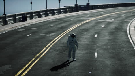 astronaut walks in the middle of a road