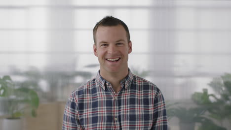 close-up-portrait-of-handsome-young-businessman-entrepreneur-laughing-cheerful-looking-at-camera-confident-caucasian-male-in-workplace