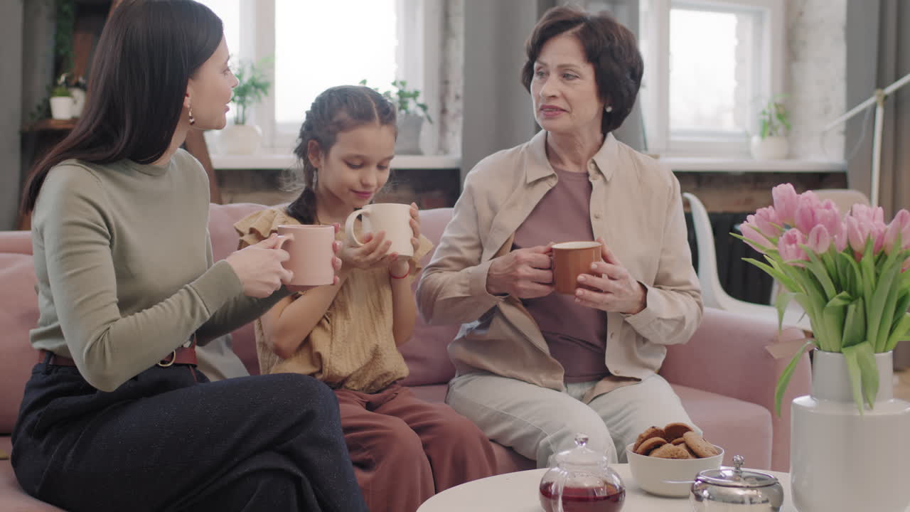 Three generations of women enjoying tea together
