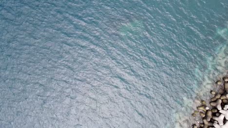 Sea-landscape-with-turquoise-water-and-concrete-tetrapod-breakwater-protection-of-the-coast