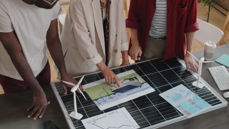 group of multiethnic engineers discussing alternative energy sources