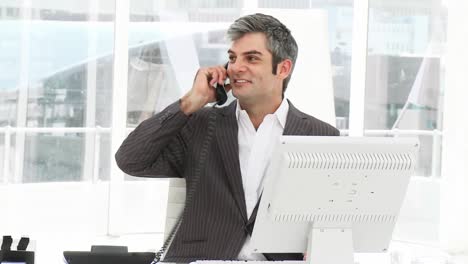 Mature-businessman-answering-phone