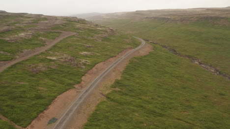 road 62 passing through iceland westfjords, long drone shot