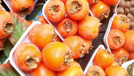 fresh persimmons at a market