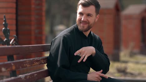 the young priest happily hides a wad of money in his pocket