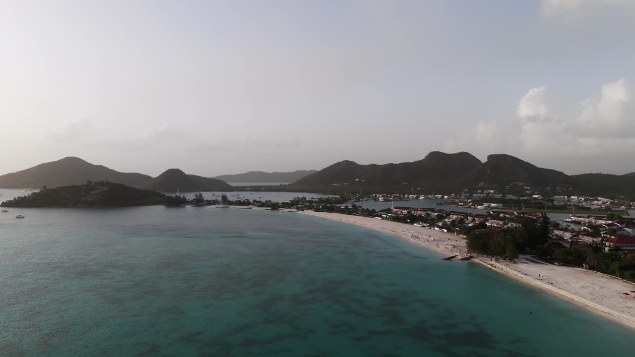 Jolly harbor's calm blue waters and coastline in antigua at dawn, aerial view