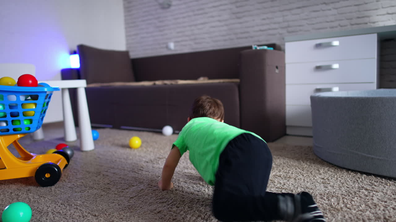 Adorable cheerful kid crawling by the floor. Happy toddler playing in his room at home.