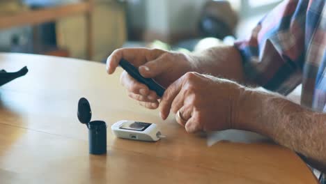 senior man checking blood sugar on glucometer 4k