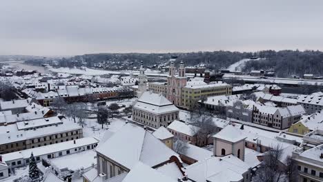 descending aerial shot of kaunas old town during winter season