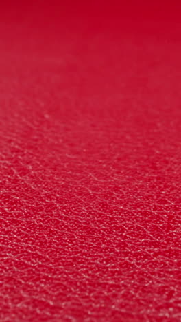 texture of cow leather surface colored bright red as background extreme close view. natural material for sewing different items. abstract wallpaper