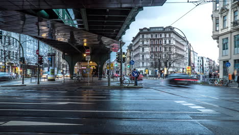 berlin crossroad with fast moving people and vehicles on a rainy day - 4k