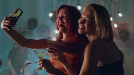 two women taking a selfie at a party