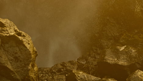 waterfall emerging from volcanic rocks