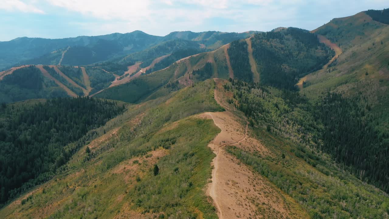Aerial View Of Mountain Range With Trail At Daytime