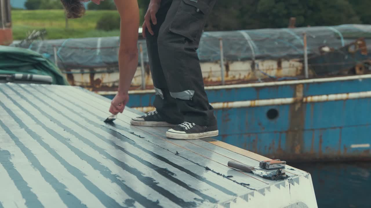 Masked off wooden boat cabin roof planking flattening sika flex sealant, MID SHOT