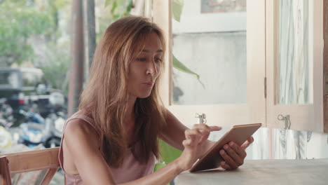 woman using tablet computer on terrace