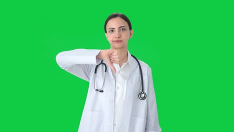 Upset-Indian-female-doctor-showing-thumbs-down-Green-screen