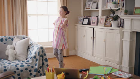 happy little girl dancing practicing ballet moves at home enjoying rehearsal dance having fun playing on weekend wearing colorful dress 4k