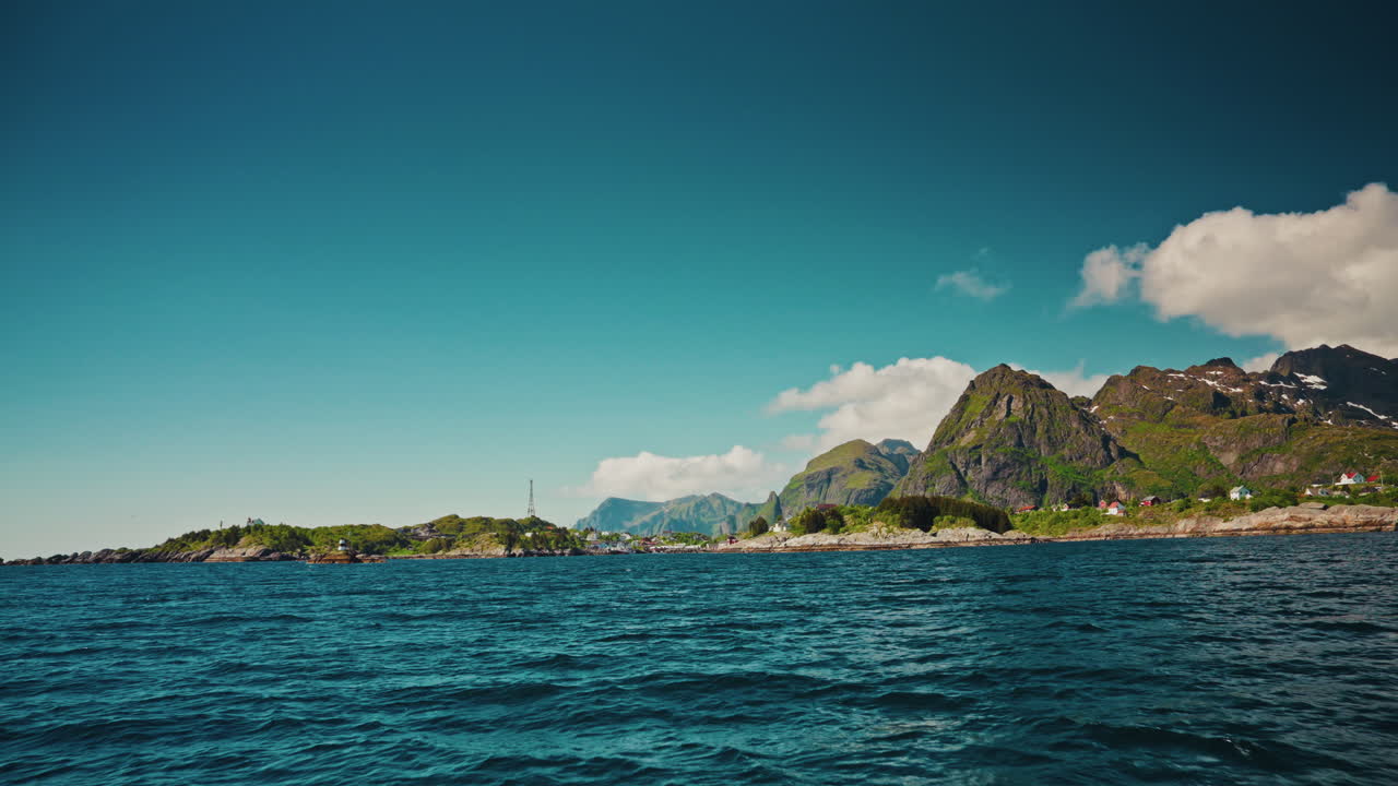 Boat tour around the fjords in Reine. Lofoten islands, Norway.
View of the Norwegian sea and the picturesque green mountainous landscape.