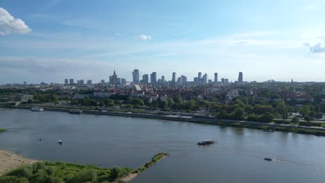 Aerial-panorama-of-Warsaw,-Poland-over-the-Vistual-river-and-City-center-in-a-distance-Old-town