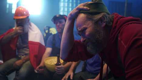 emotional sports fans reacting to a game with a polish flag