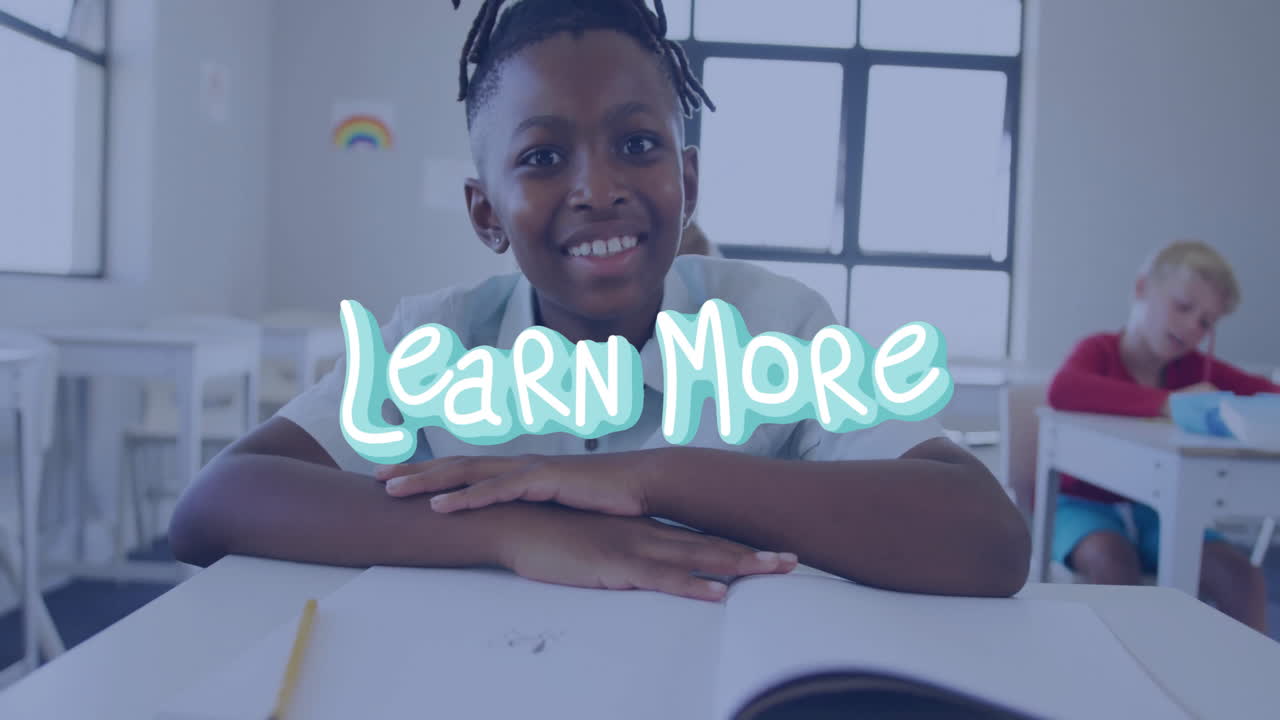 In school, child watching animation with Learn More text overlay in classroom