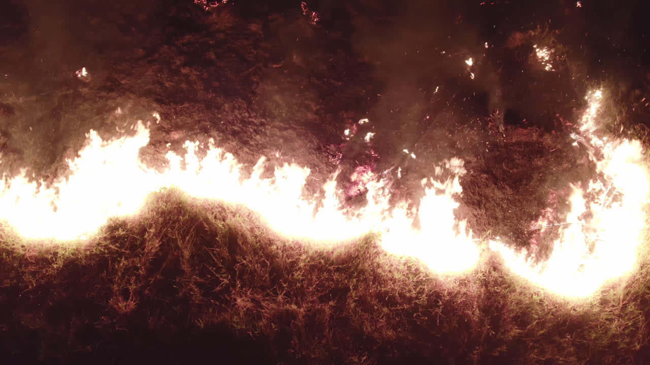 Fire flame of wild fire at night. Aerial drone view of the wild fire.