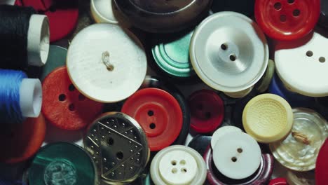 sewing buttons. close-up. rotation. various round colored sewing buttons rotate on turntable. loop motion background. concept of color, fashion, dressmaking, sewing, tailor