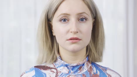 portrait of young blonde woman with blue eyes.