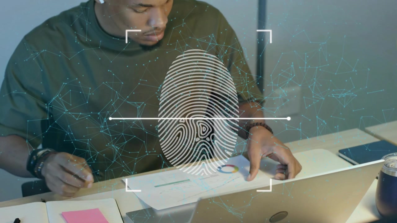 Tech analyst reacting to biometric overlay while writing notes, using trackpad and analyzing charts