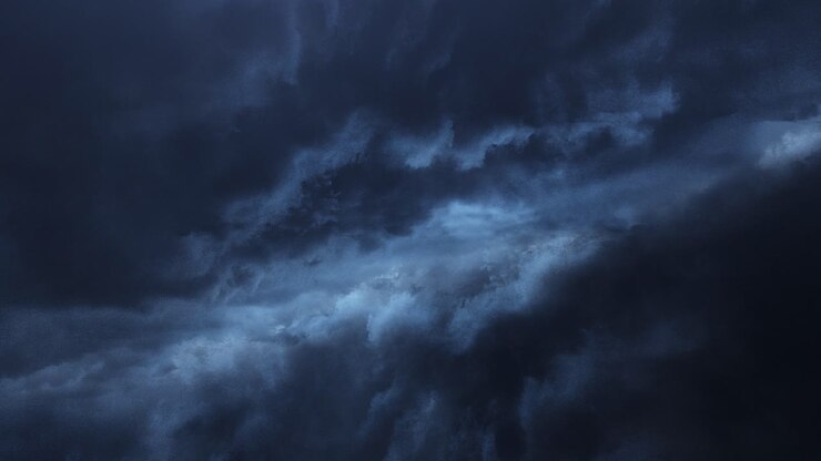 thunderstorm between two dark clouds in the sky